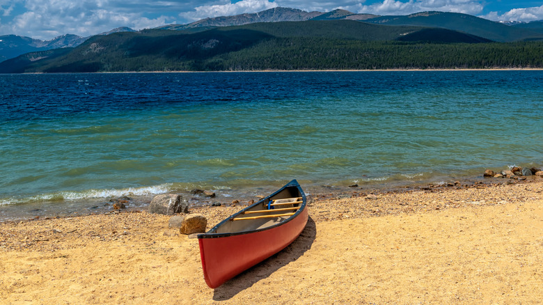 A red canoe on the shore of Turquoise Lake
