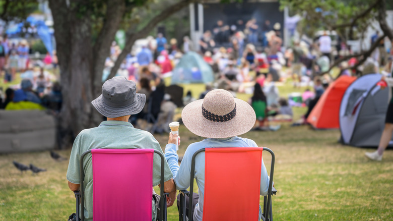 Couple sitting at a live show in a park