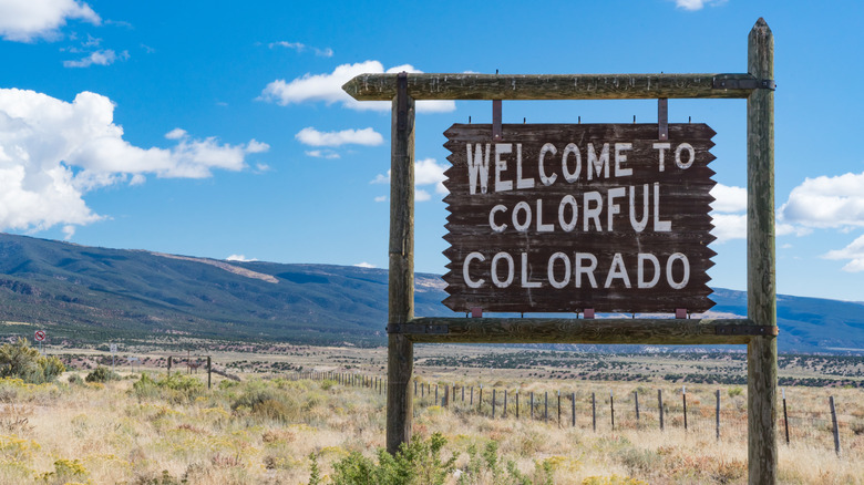 'Welcome to Colorful Colorado' sign in Mack, CO, near the Colorado and Utah border.