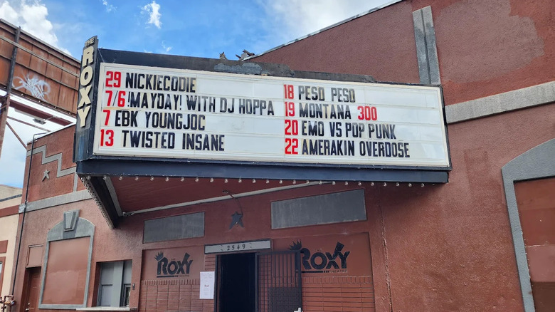 Outside The Roxy in Five Points with its brick wall and list of performers