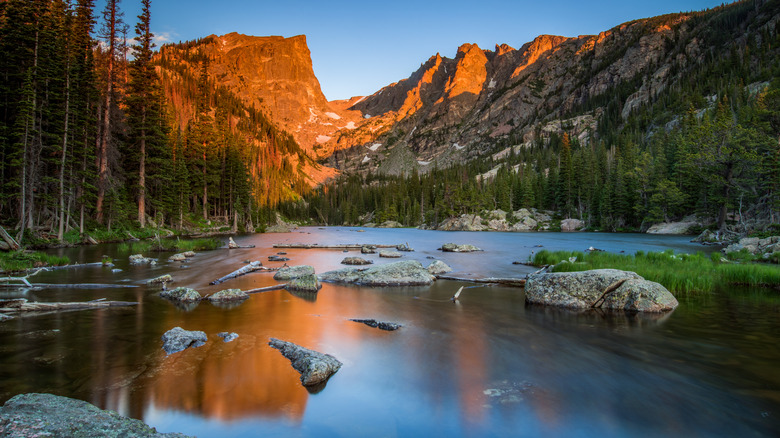 A beautiful stream in Rocky Mountain National Park with a sunset-lit mountain in the background
