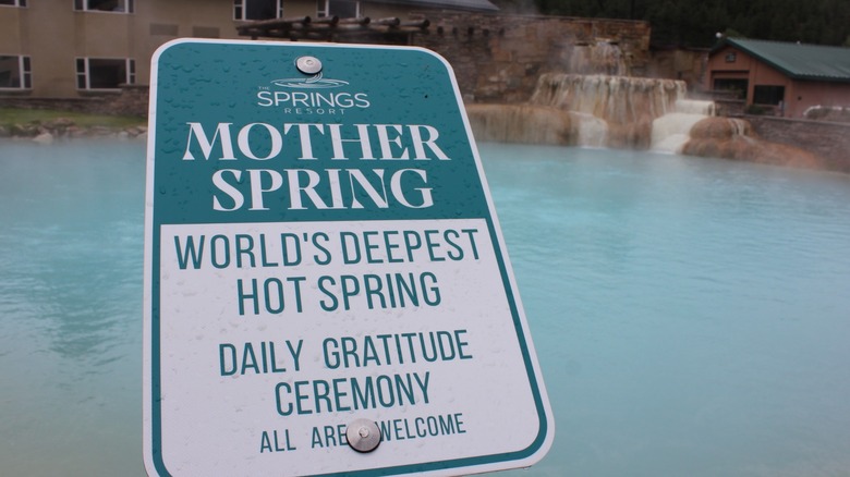 The Mother Spring sign in front of blue water in Pagosa Springs, Colorado