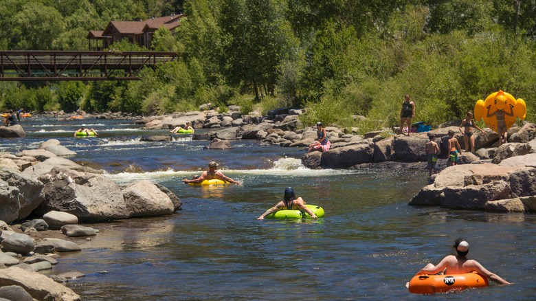 People floating in inflatable tubes down the San Juan River during hot summer day in Pagosa Springs, Colorado