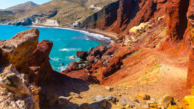 A stunning rust-colored stretch of beach in Santorini