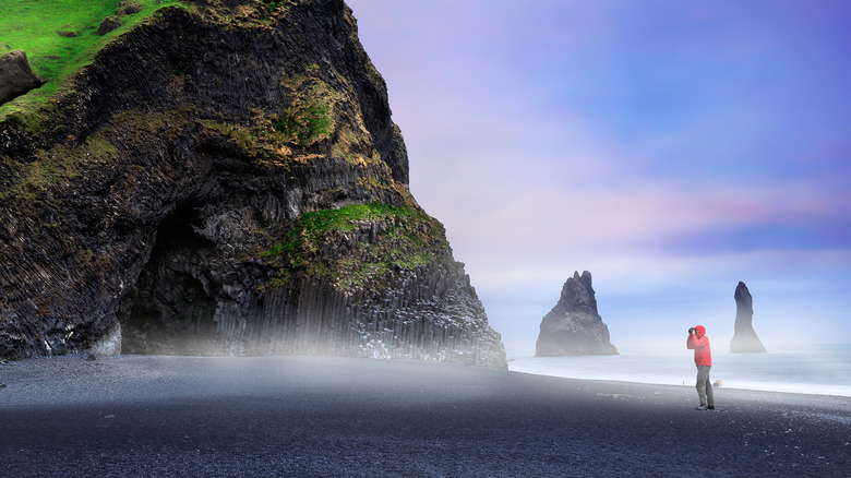 a traveler taking photos of Reynisfjara Beach
