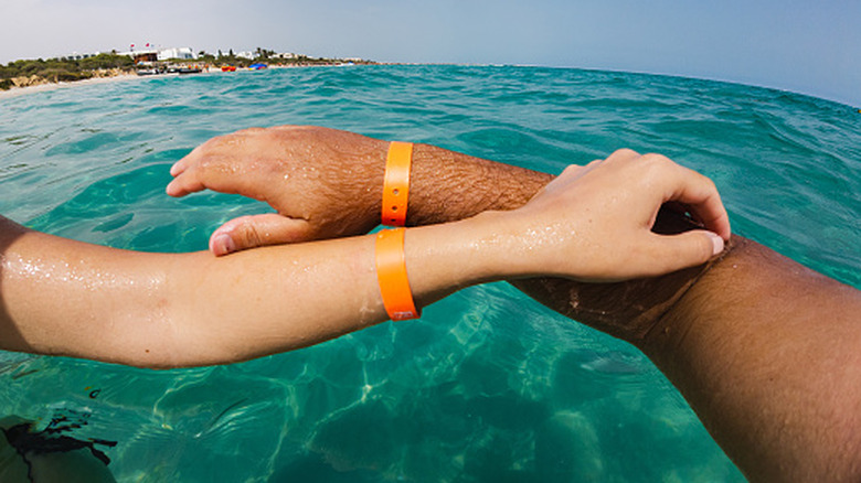 A couple wearing their all-inclusive wristbands