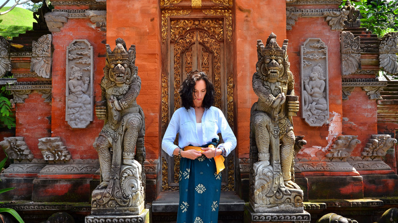 Woman in a log sleeve top at a temple