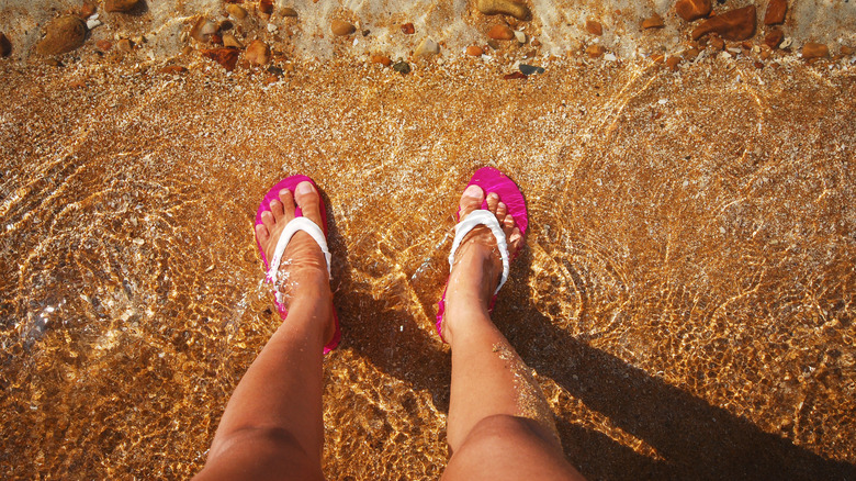 Woman wearing flip flops on a beach
