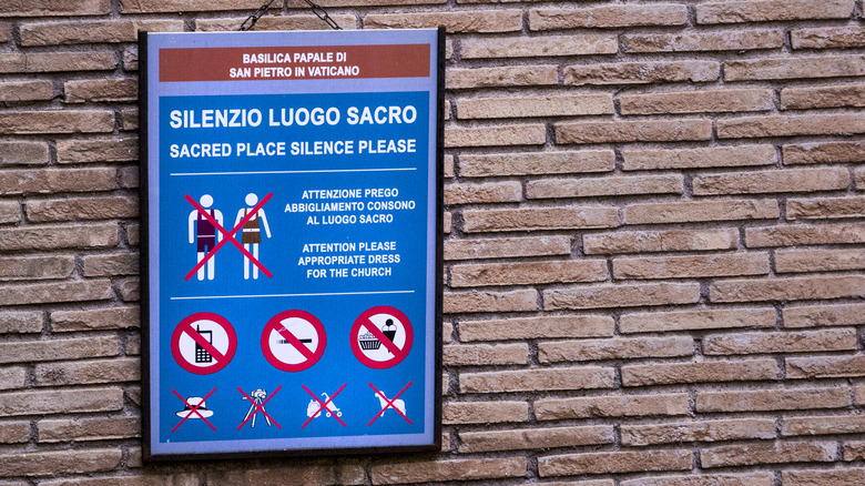 Vatican City dress code sign on a brick wall