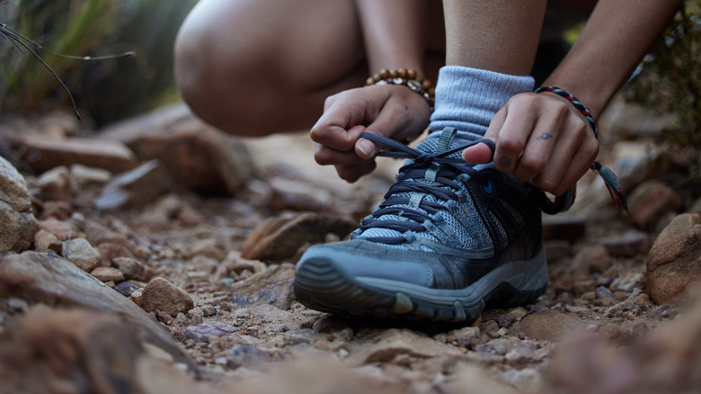 Woman lacing up hiking boots