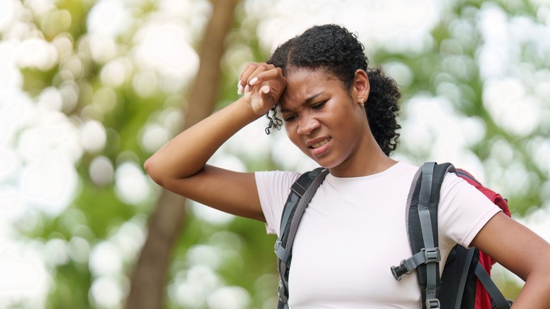 A woman sweating while hiking