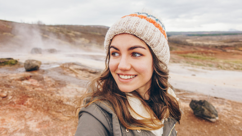 Woman smiling with a hat on in Iceland