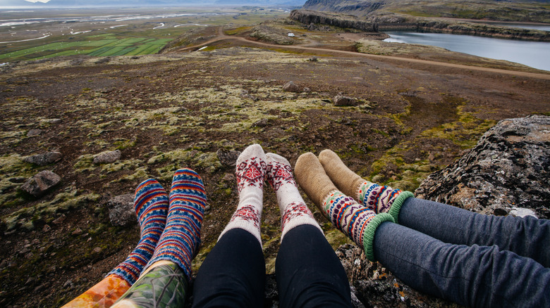 View of girls wearing fun and colorful socks on a hill in Iceland