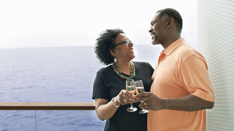 A couple enjoys wine on board a ship