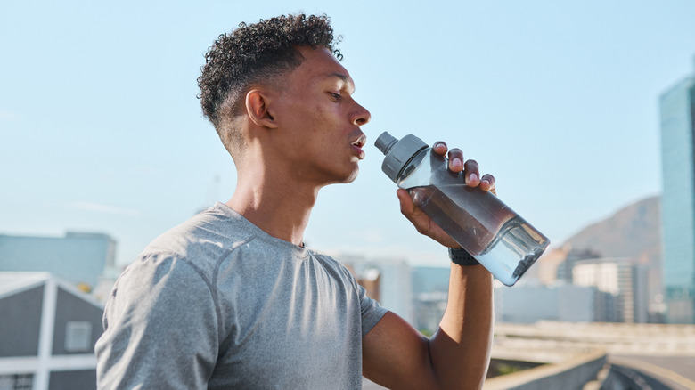 Person drinking water to cool down on a hot day