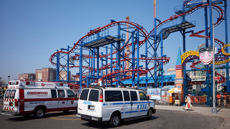 A police vehicle and an ambulance at Coney Island Amusement Park.