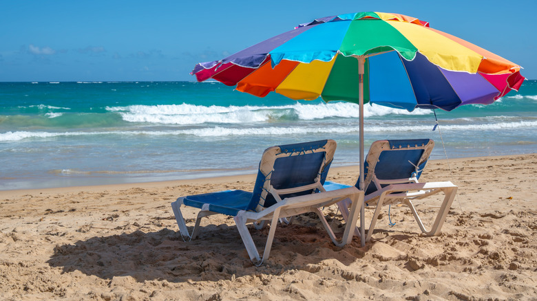 loungers and umbrella on the golden sands of Condado beach