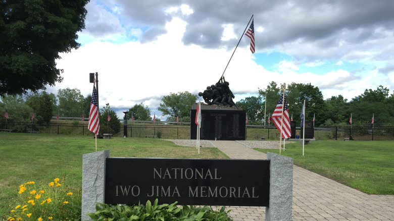 A view of the National Iwo Jima Memorial, with a sign and a monument
