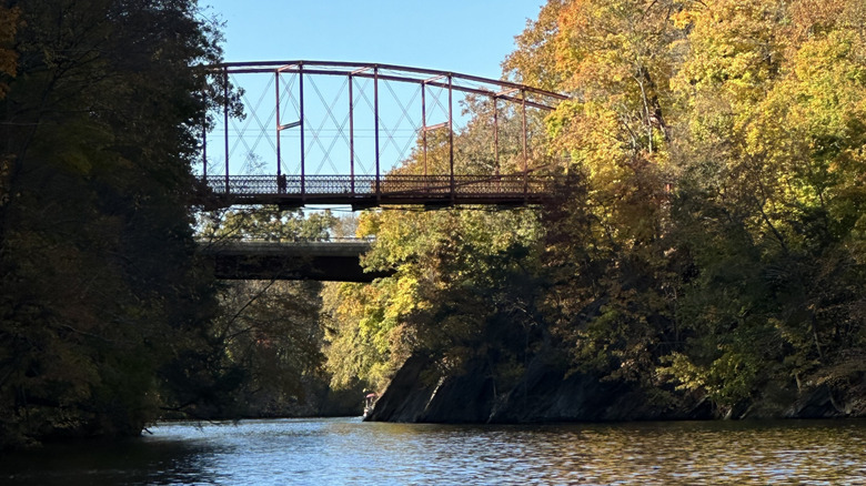 People walking over the 1800s iron walking bridge that crosses over Lake Lillinonah.