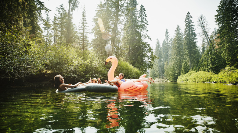 People floating down a river in an inner tube