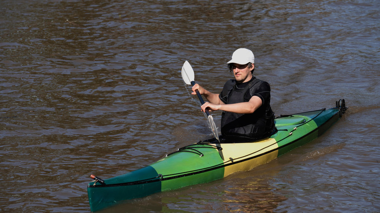 Man paddling a kayak on the open water