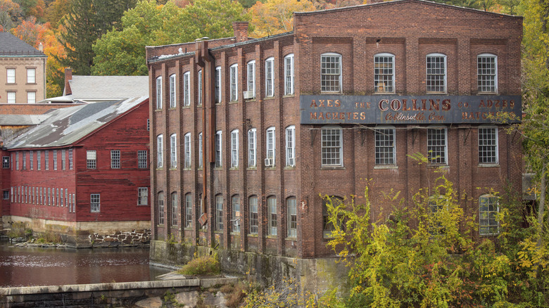 A historic building in Collinsville, Connecticut, surrounded by fall foliage