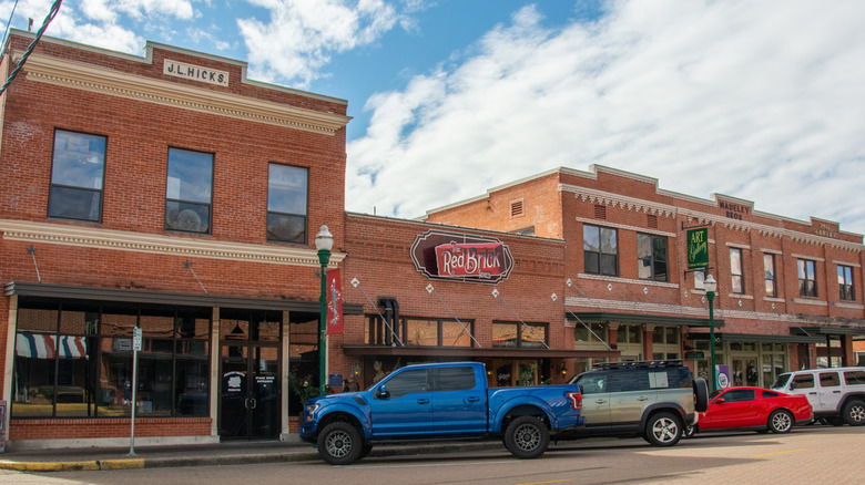 Exterior of red brick storefronts and The Red Brick Tavern in Conroe, Texas.