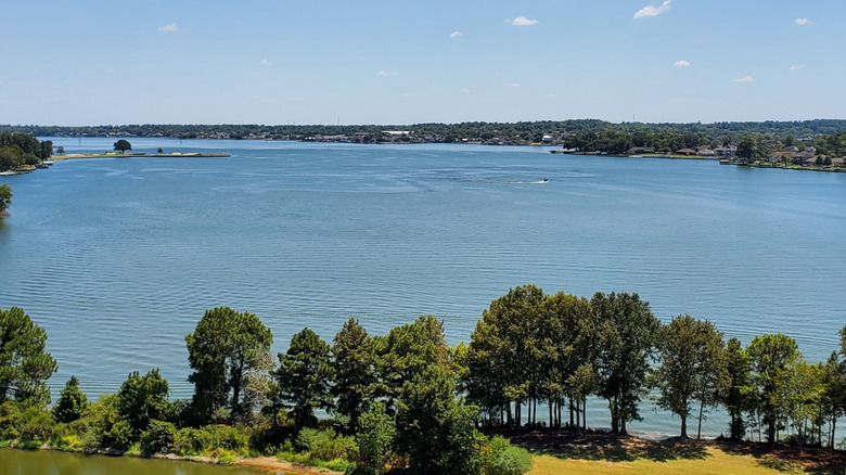 Beautiful views of Lake Conroe from waterfront parks with grass and shady trees.