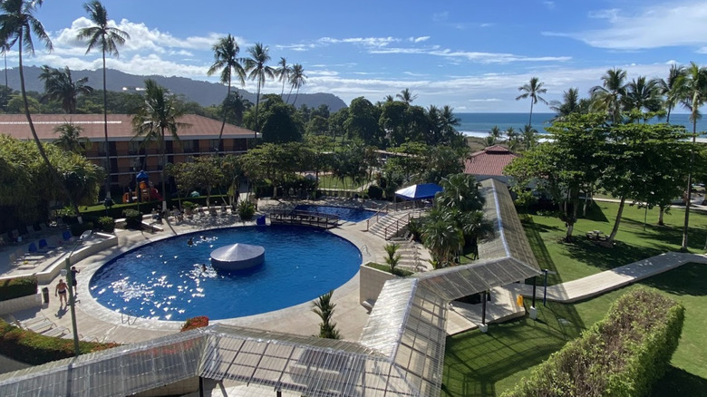 Pool area overlooking the beach at Best Western Jaco Beach Resort in Costa Rica