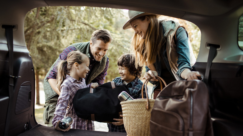 Family packing a car for a trip