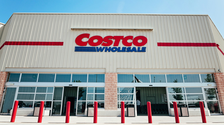 A sign for Costco Wholesale on the front of a warehouse store