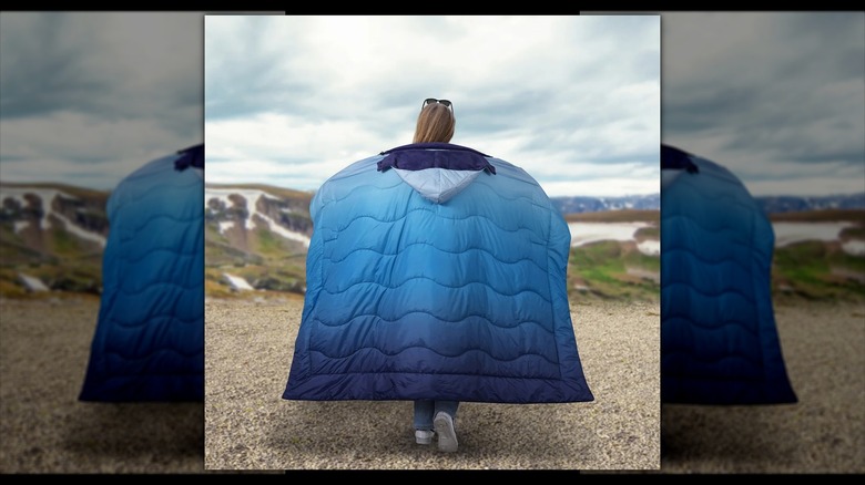 Woman wearing blue blanket with hood