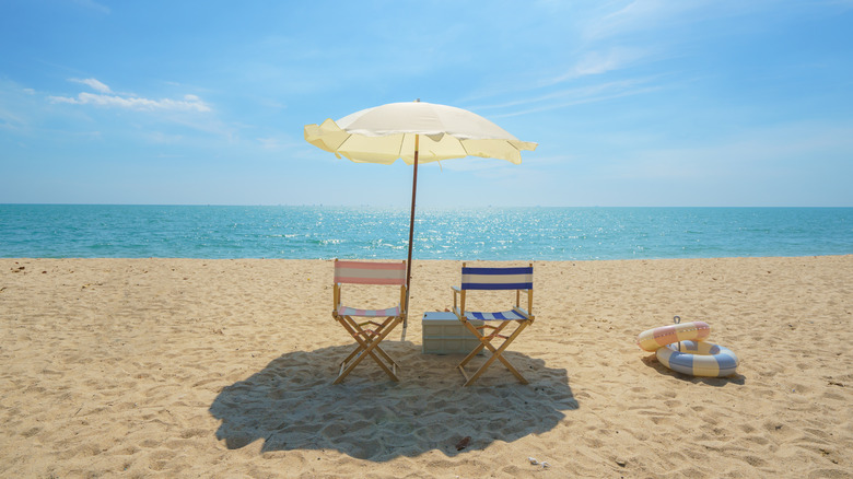 Two chairs and an umbrella on the beach