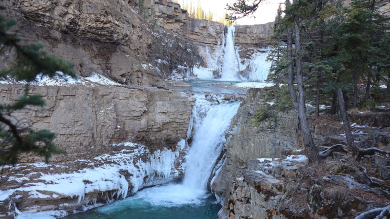 Crescent Falls flowing in winter, among icy cliffs.