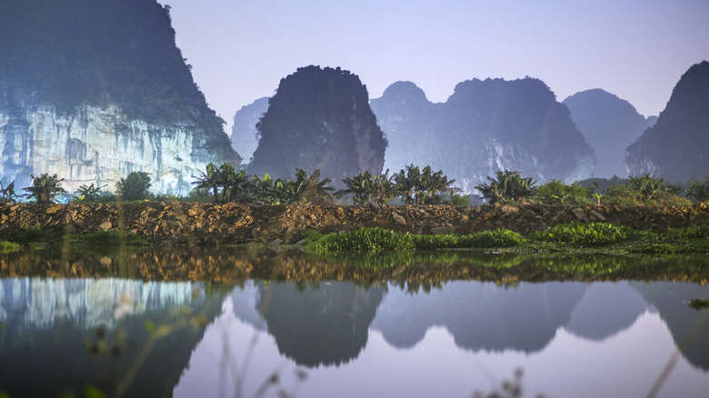 Karts peaks reflecting in the water at Ninh Binh