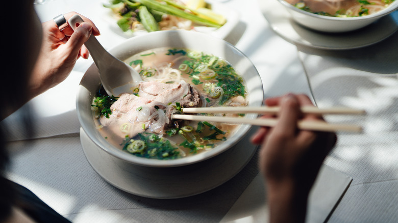 Eating pho, the national dish of Vietnam