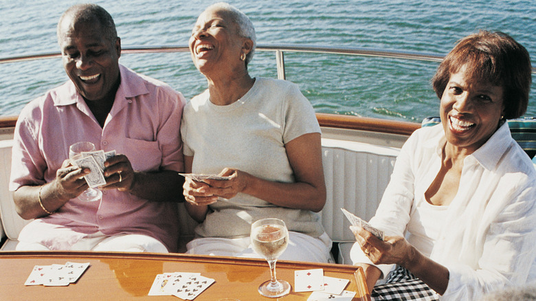 People laughing and playing cards on a boat