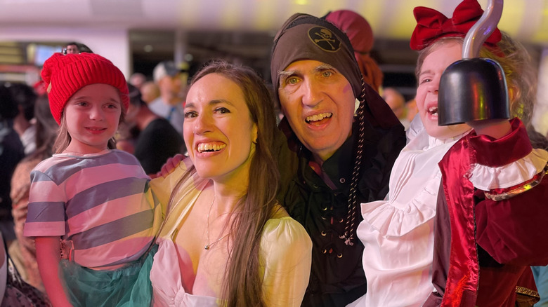 Multigenerational family in pirate themed attire for Disney Cruise Line's pirate night onboard the Disney Wish
