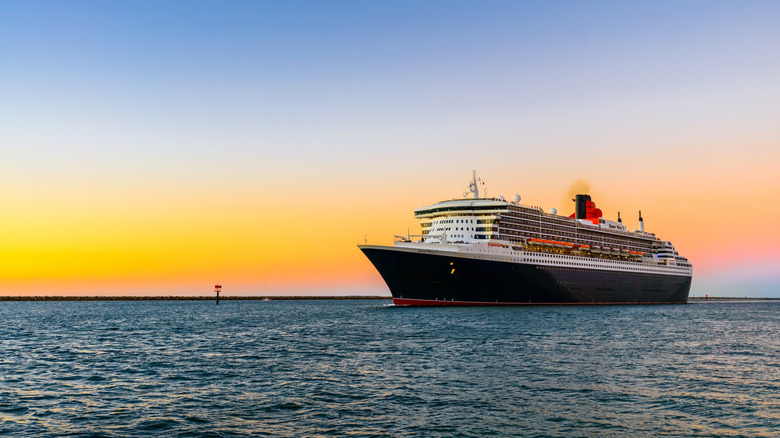 Cunard's Queen Mary 2 cruise ship in open water at sunset