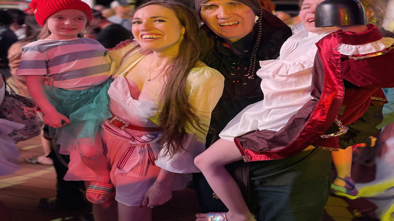 Multigenerational family in pirate themed attire for Disney Cruise Line's pirate night onboard the Disney Wish