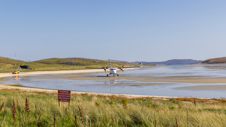 Plane on the unique sandy runway of Barra Airport