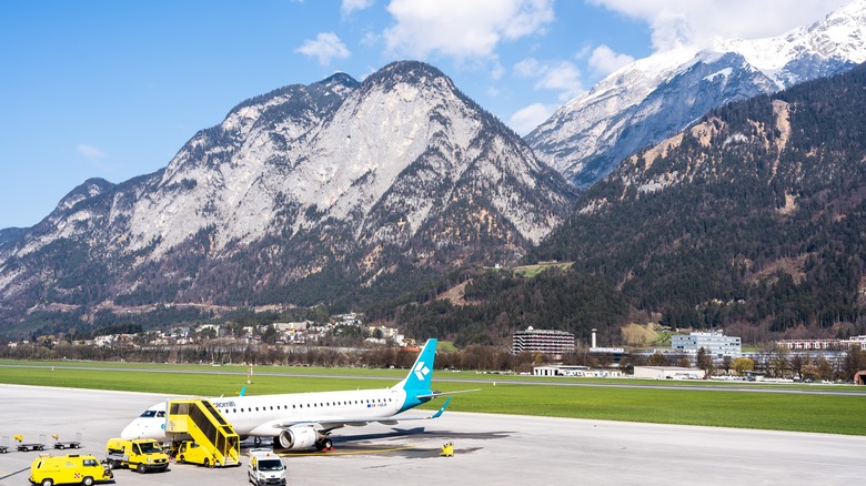 Plane with mountains in the background at Innsbruck Airport
