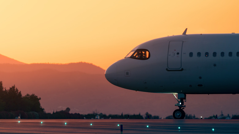 Closeup of a plane with sunset in the background