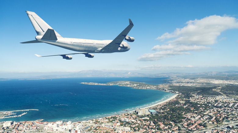 Plane flying into a coastal destination