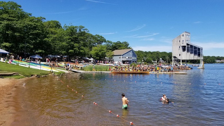 Boats and people swimming in Lake Banook on a clear day