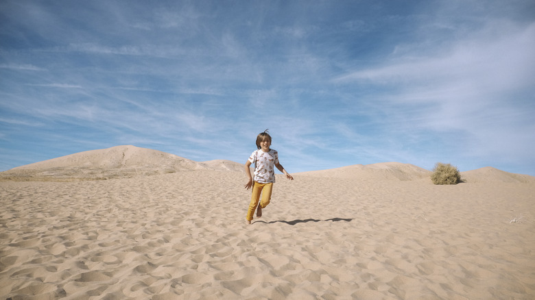 A child running on dunes