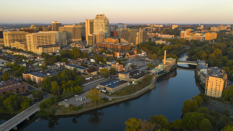 An aerial view of Wilmington, Delaware, with lots of greenery and buildings lit by a low sun