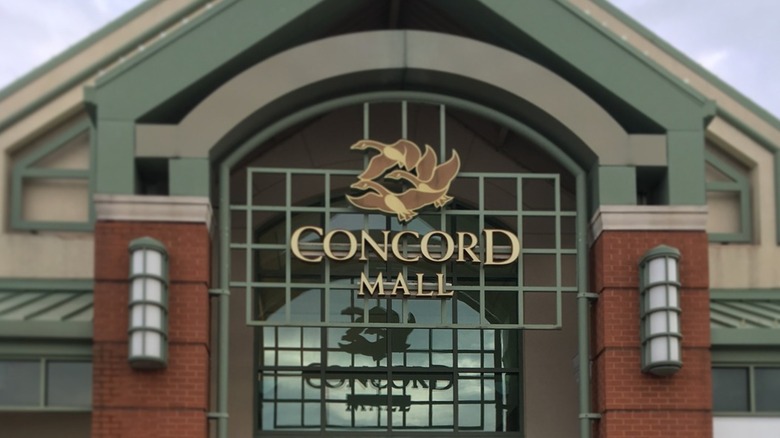 Metal and brick facade of Concord Mall with a sign