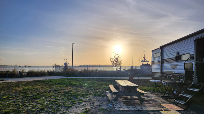 A travel trailer camp site in Delaware Seashore State Park with a picnic table