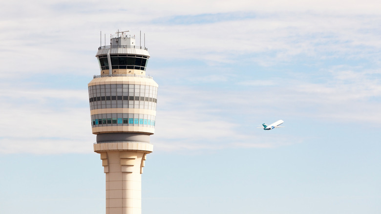 Air traffic control tower and plane
